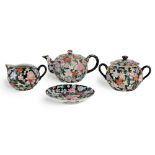 A Chinese famille rose millefleurs tea set, Republic period, comprising a milk jar, a saucer, a