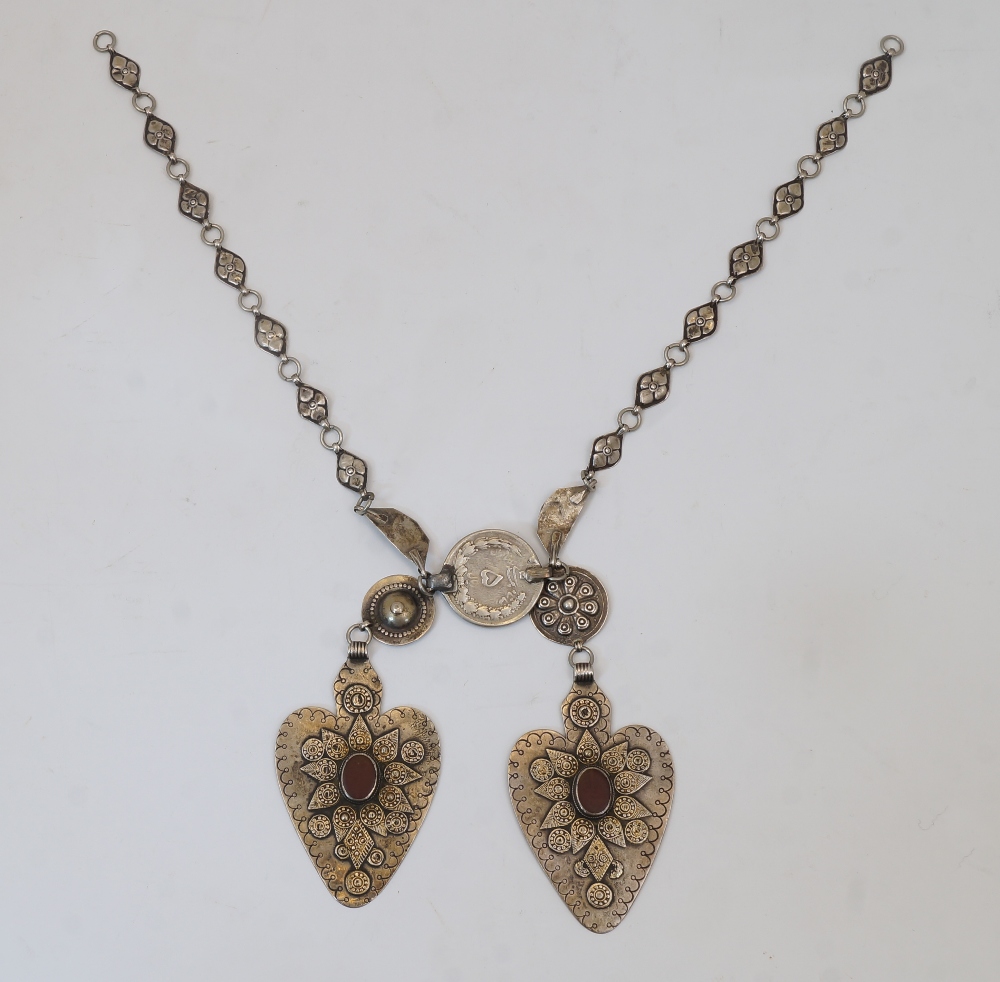 A silver Tekke collar, Turkmenistan, 19th century, the necklace formed of two heart-shaped panels
