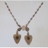 A silver Tekke collar, Turkmenistan, 19th century, the necklace formed of two heart-shaped panels