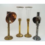 A group of four spring-loaded candlesticks, to include a late Victorian brass student's