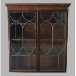 A mahogany bookcase, 19th century, with two brass astragal glazed doors, enclosing adjustable