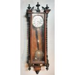 A mahogany and ebonised Vienna regulator style wall clock, 20th century, with broken arched pediment