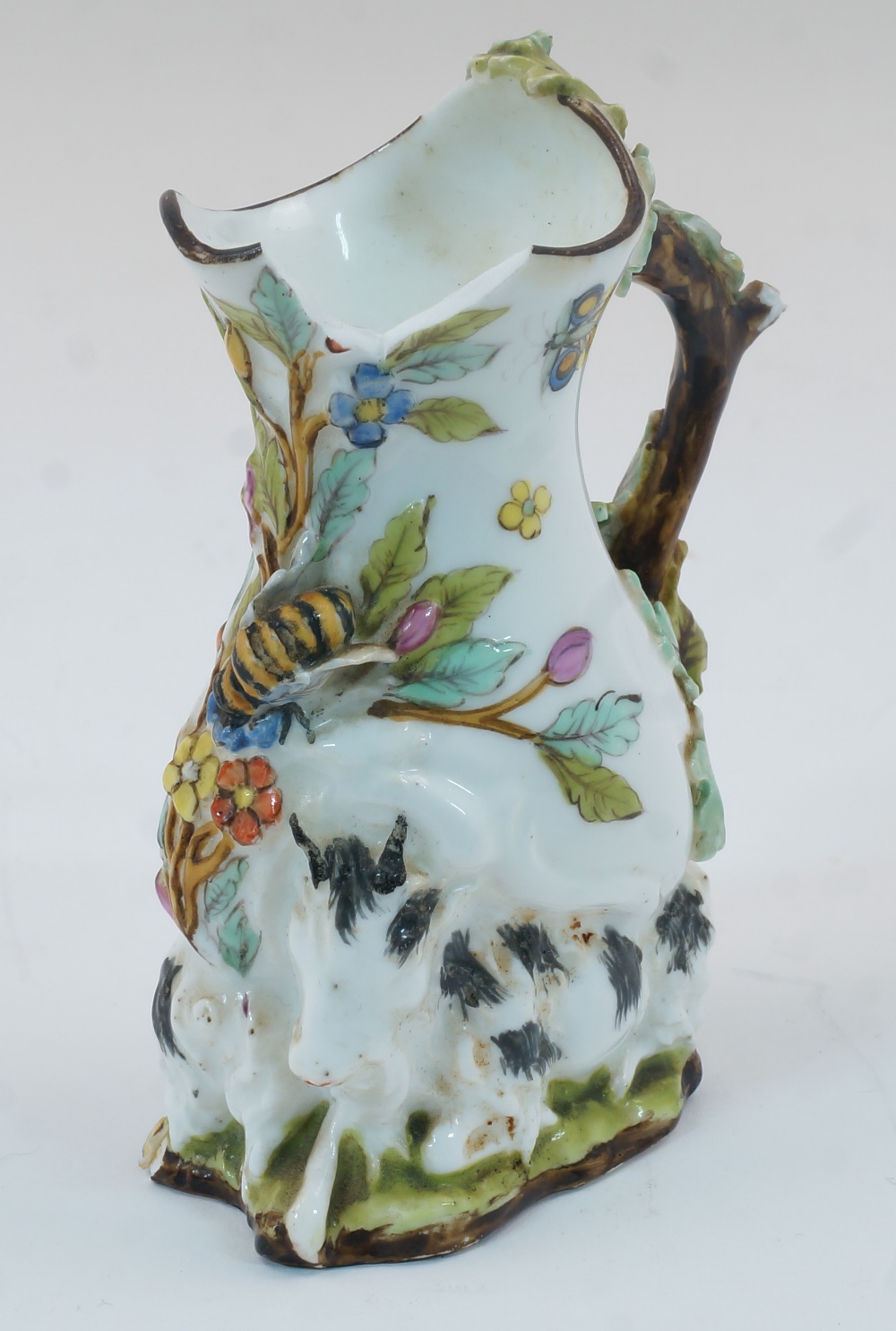 A Chelsea style goat and bee jug, probably 19th century, of typical form with applied foliage and