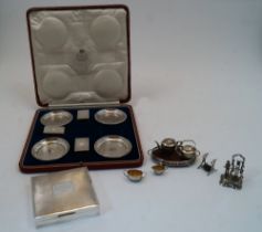 A cased set of four silver ashtrays and three matchbox covers, one matchbox cover missing, London,