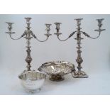 A pair of silver plated three light candelabra, on knopped and foliate decorated stems and shaped