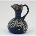 An Eastern Mediterranean marbled opaque blue and yellow glass jug, after the Antique, 10cm