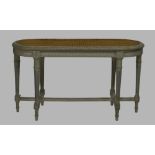 A French grey painted caned window stool, early 20th century, raised on fluted supports, joined by