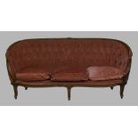 A French mahogany sofa, 20th century, with pink button back velour upholstery, raised on cabriole