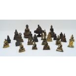 A group of twenty four small bronze Asian seated Buddhas, 20th century, including Thai and Chinese