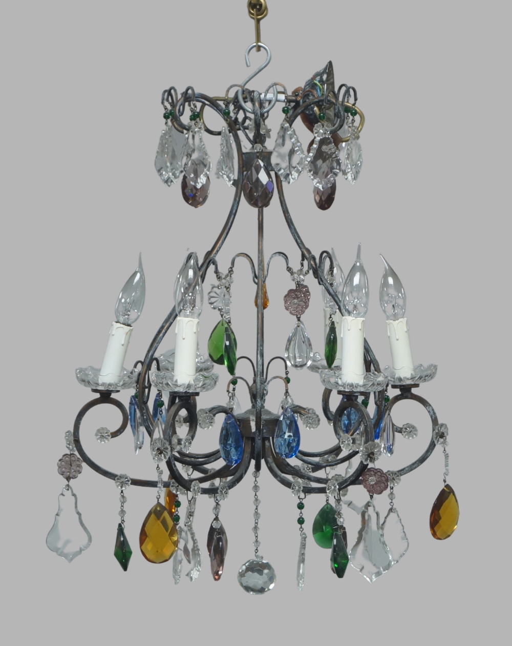 A modern metalwork and glass six-light chandelier, of open cage form, hung with coloured and clear