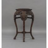 A Chinese hardwood jardinière stand, early 20th century, of octagonal form, the pierced frieze