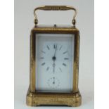 A French gilt-brass repeating alarm carriage clock, early 20th century, the case chased with foliate