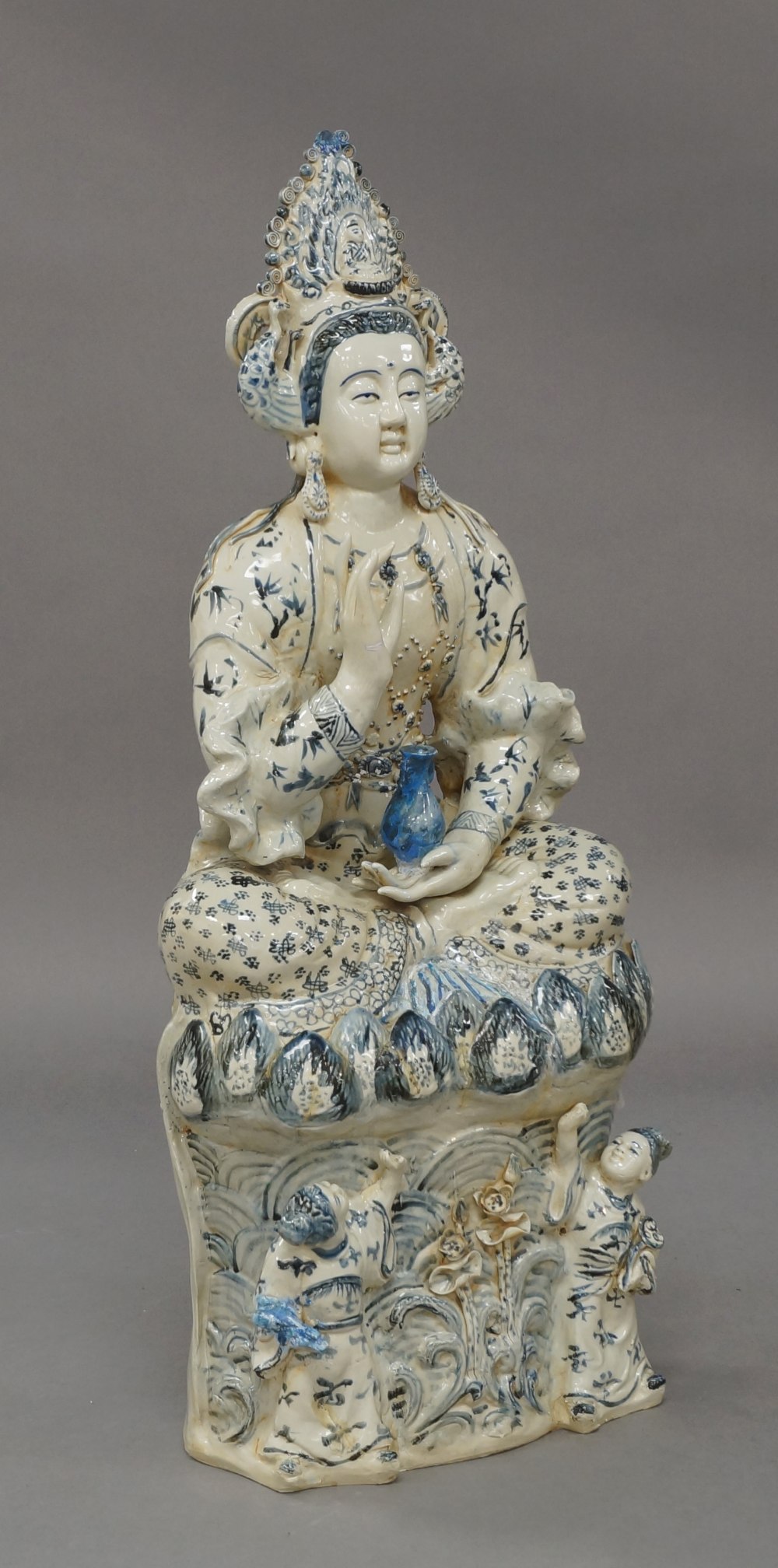 A large Chinese porcelain blue and white figure of Guanyin, 20th century, seated cross-legged on a - Image 2 of 3