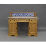 A Victorian pine marble top dressing table, the gallery top set with tiles, above three drawers