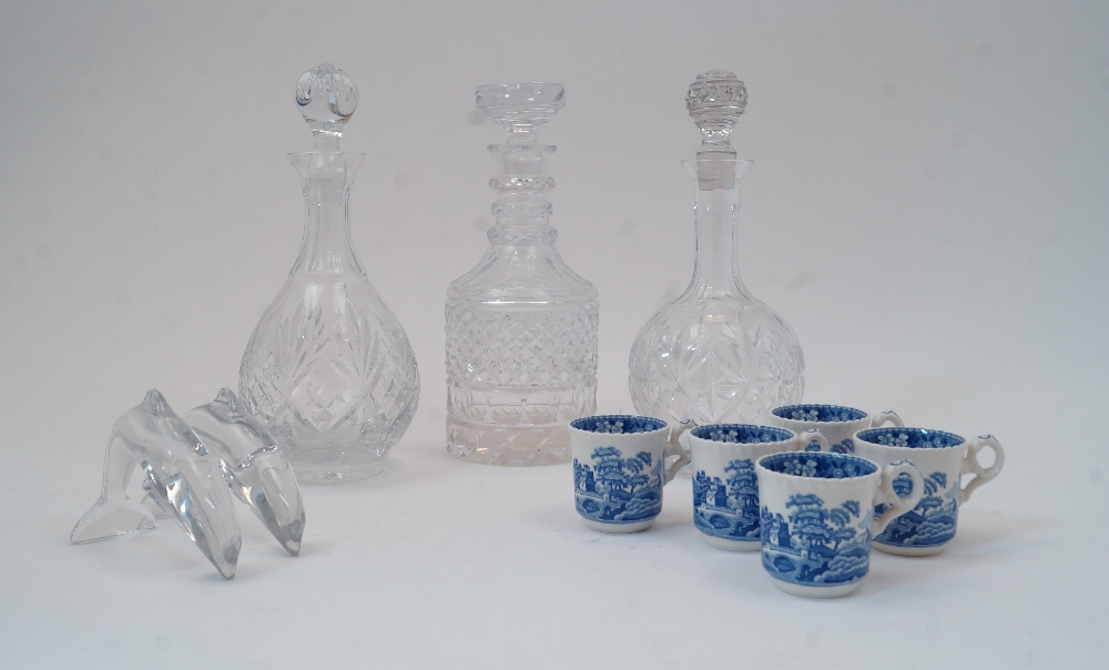 Three glass decanters and stoppers, tallest 28cm high, together with a pair of satin cushions