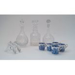 Three glass decanters and stoppers, tallest 28cm high, together with a pair of satin cushions