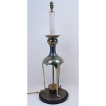 A brass table lamp, 20th century, the faux candlestick electrical fittings with large sconce atop