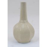 A Southern Chinese earthenware cream crackle glazed ribbed bottle vase, early 20th century, with