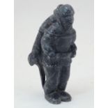 Isa Smiler, Inuk, 1921-1986, a stone carving of an Inuit hunter with an otter strapped to his