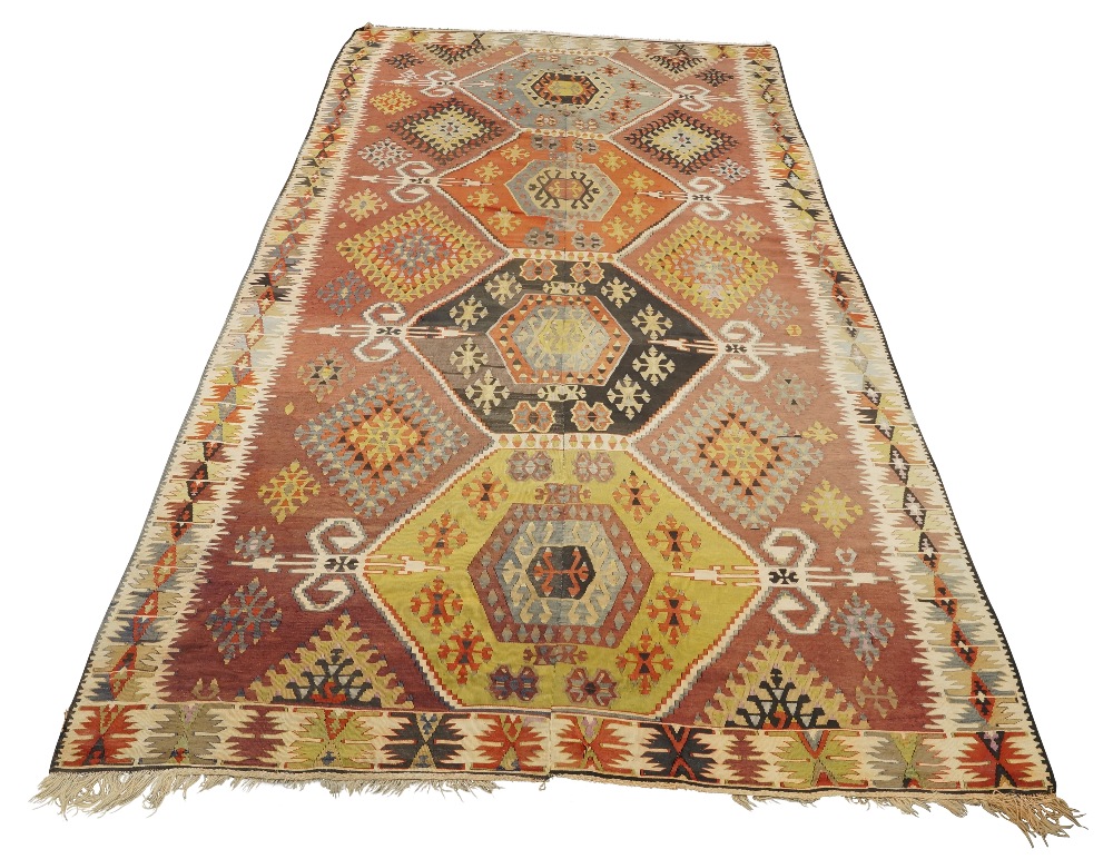 A large kilim carpet, 20th century, with four geometric medallions surrounded by geometric motifs