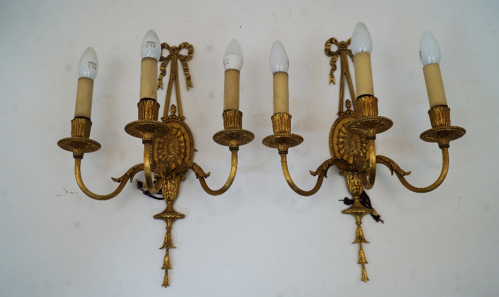 A set of four gilt bronze three-branch wall appliques, late 20th century, with ribbon-tied - Image 2 of 2