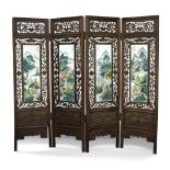 A Chinese hardwood and porcelain four fold screen, carved and pierced with bats and flowers,