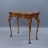 A Queen Anne style walnut fold over card table, late 20th century, with single drawer raised on