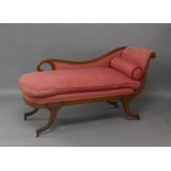 A Regency style mahogany chaise lounge, late 19th/early 20th century, with scrolling ends, raised on