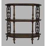 A Victorian burr walnut and boxwood inlaid three tier whatnot, reeded column supports, raised on
