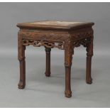 A Chinese hardwood jardiniere stand, 20th century, inset with marble top, carved and pierced frieze,