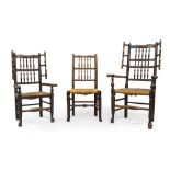 A near pair of oak wing back armchairs, 18th century, with turned spindle back rests and rush seats,