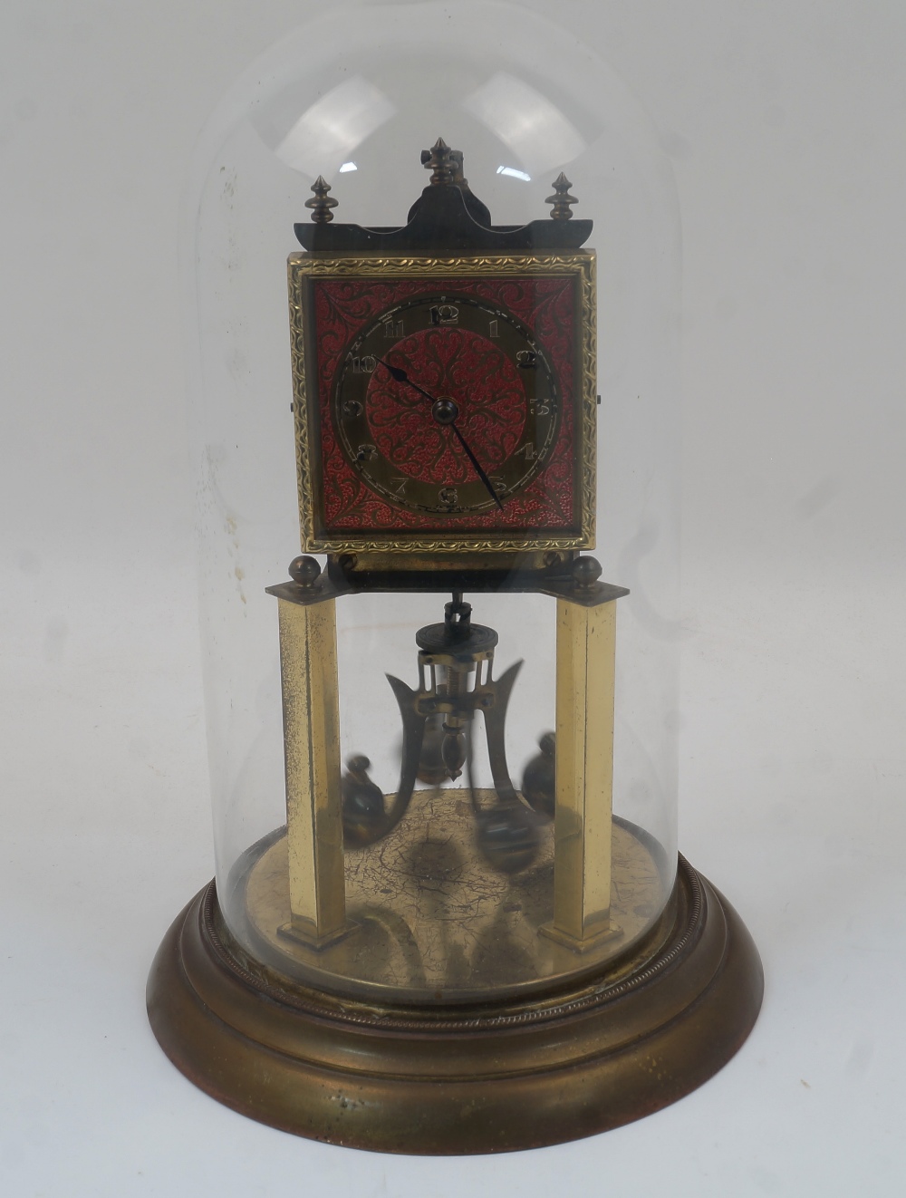 A brass anniversary clock, 20th century, with an adjustable four ball rotary pendulum, the square