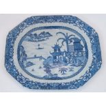 A large Chinoiserie hexagonal blue and white ceramic platter, 20th century, decorated to the well