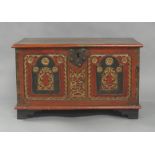 An Indian painted teak trunk, early 20th century, the front with floral carvings, the hinged lid