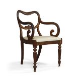 A William IV mahogany open arm elbow chair, with carved floral back rail, above drop in seat, raised
