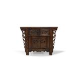 A Chinese elm side cabinet, early 20th century, the rectangular top above two drawers, carved with