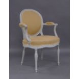 A French white painted fauteuil, 20th century, beige upholstery, raised on fluted supportsPlease