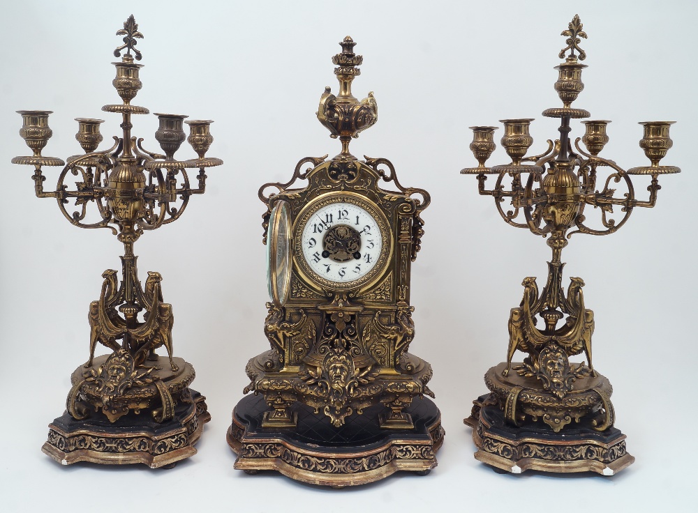 A gilt-brass clock garniture, by H. Luppens et decoration, flanked by five light candelabra, all