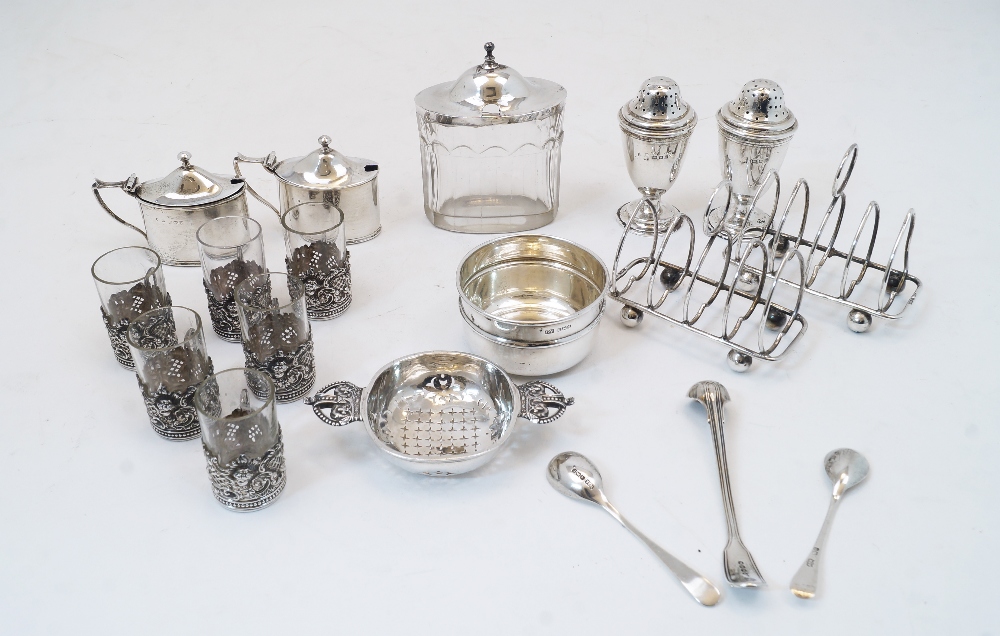 A group of silver comprising: a Britannia silver tea strainer, by F T Ray & Co., with crown