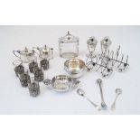 A group of silver comprising: a Britannia silver tea strainer, by F T Ray & Co., with crown