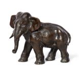 A Japanese bronze figure of an elephant by Yoshimitsu, Meiji period, cast with long curling trunk,
