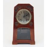 An Arts and Crafts style clock, 20th century, the stained wood case of tapering rectangular form