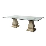 A glass top dining table, raised on variegated stone pedestals, of fluted baluster form, glass top