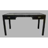 Pierre Vandel, Paris, a black metal framed desk fitted two drawers and glass top, 75cm high, 140cm