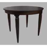 A modern mahogany circular table, raised on cylindrical supports to brass caps, 75cm high, 100cm