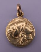 An unmarked high carat gold, possibly 22 ct, pendant. 1.5 cm diameter. 6.4 grammes.