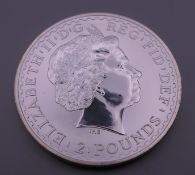 A silver Britannia coin, in capsule and case.