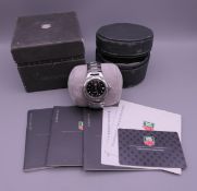 A boxed Tag Heuer wristwatch with booklets and card.