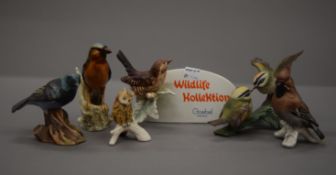A collection of Goebel birds. The largest 12.5 cm high.