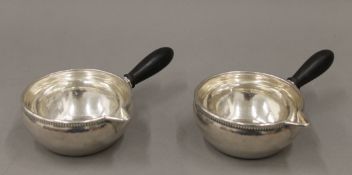 A pair of Georg Jensen sterling silver sauce ladles. Each 16.5 cm long.